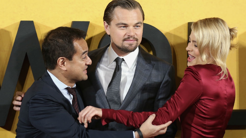 Riza Aziz, left, Najib's stepson and a coproducer of The Wolf of Wall Street on the red carpet in London with the film's leads, Leonardo DiCaprio and Margot Robbie [Paul Hackett/Reuters]