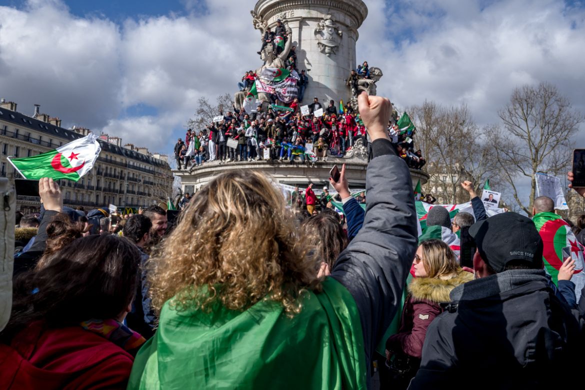 An Algerian protester raises her fist while an estimated 10.000 Algerian protesters attend a demonstration against Algerian President Abdelaziz Bouteflika in Place de la RE`publique in Paris, France.