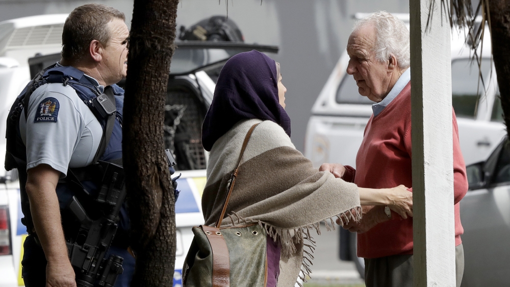 Police escort people away from outside a mosque in central Christchurch, New Zealand [Mark Baker/The Associated Press]