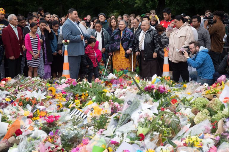 Samoan church members sing next to floral tributes in Christchurch on March 17, 2019, two days after a shooting incident at two mosques in the city.