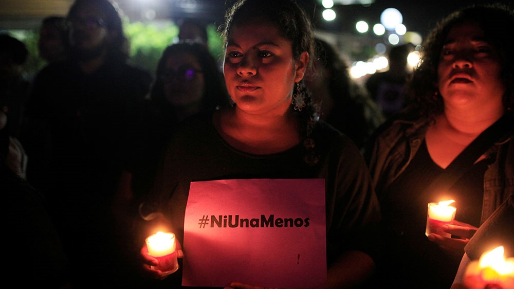 Activists hold a sign reading, 'not one more' during a protest against violence against women in El Salvador [File: Jose Cabezas/Reuters]