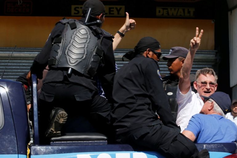 A demonstrator gestures as he is detained by riot police during a protest against the government of Nicaragua''s President Daniel Ortega in Managua