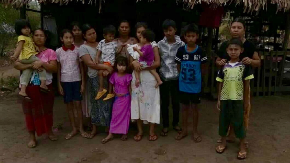 Han Win Naung's family outside their home in Myanmar's southern Tanintharyi region [Han Win Naung/Al Jazeera]
