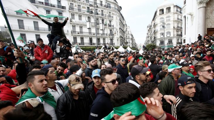People carry national flags during a protest calling on President Abdelaziz Bouteflika to quit, in Algiers
