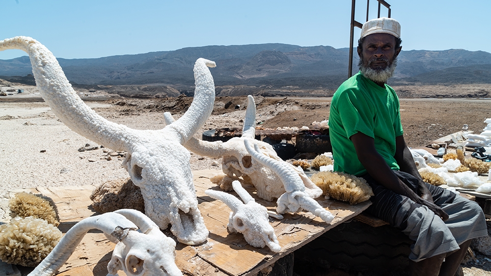 Hummad Musa says most of the tourists that visit this desolate region simply take photos of the salt-encrusted skulls of antelopes and gazelles before leaving [Faisal Edroos/Al Jazeera]