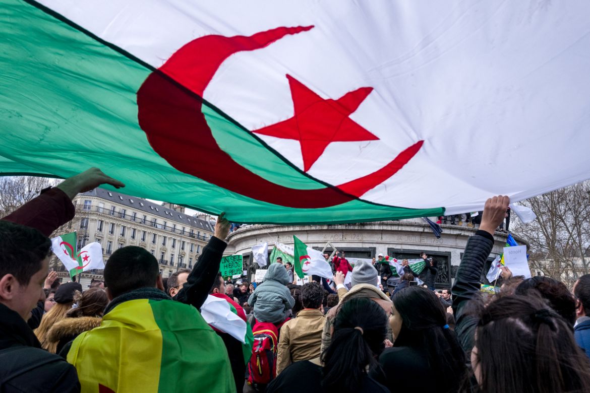 Algerian protesters wave an Algerian flag during a demonstration against Algerian President Abdelaziz Bouteflika seeking a fifth term in Place de la RE`publique in Paris, France. Photo by Omar Havana