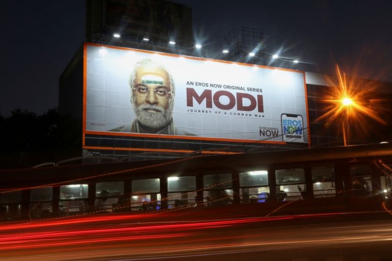 Traffic moves past a billboard of a web series "Modi: Journey of a Common Man" in Mumbai