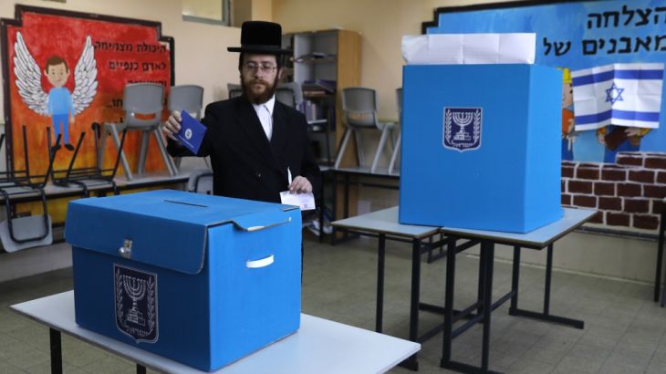 An ultra-Orthodox Jewish man casts his vote during Israel''s parliamentary elections in Jerusalem [Menahem Kahana/AFP]
