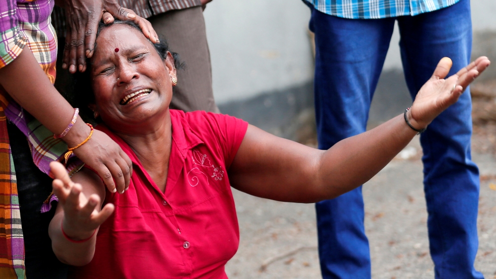 A relative of a victim of the explosion at St Anthony's Shrine, Kochchikade church, reacts at the police mortuary in Colombo [Dinuka Liyanawatte/Reuters]