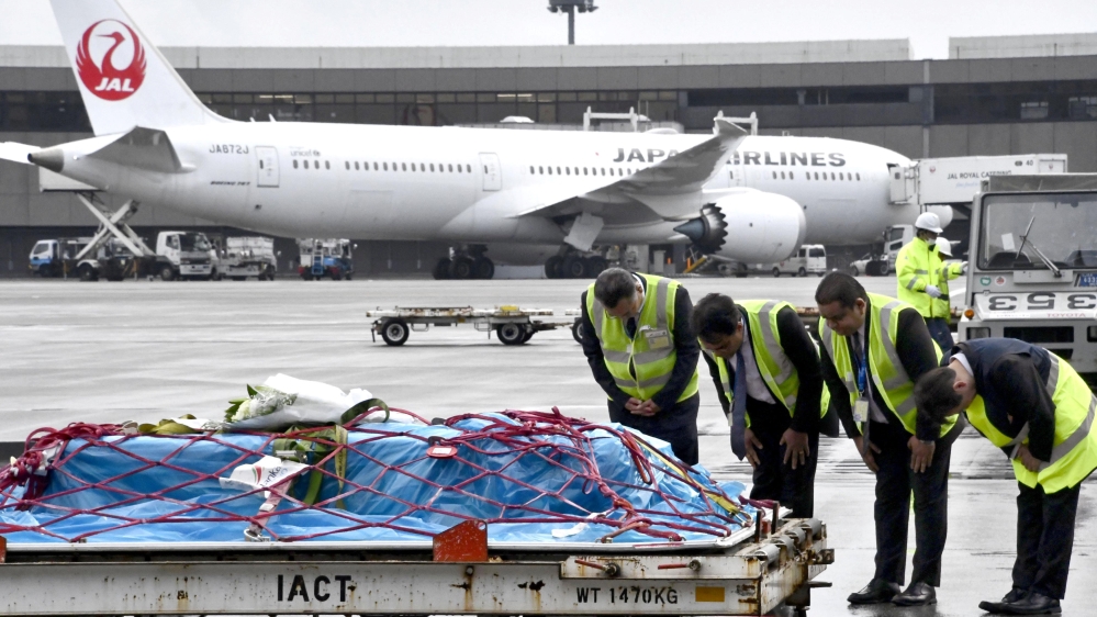 A coffin containing the body of Kaori Takahashi, a Japanese woman killed in the bombings in Sri Lanka, arrives at Narita international airport in Japan [Kyodo/via Reuters]