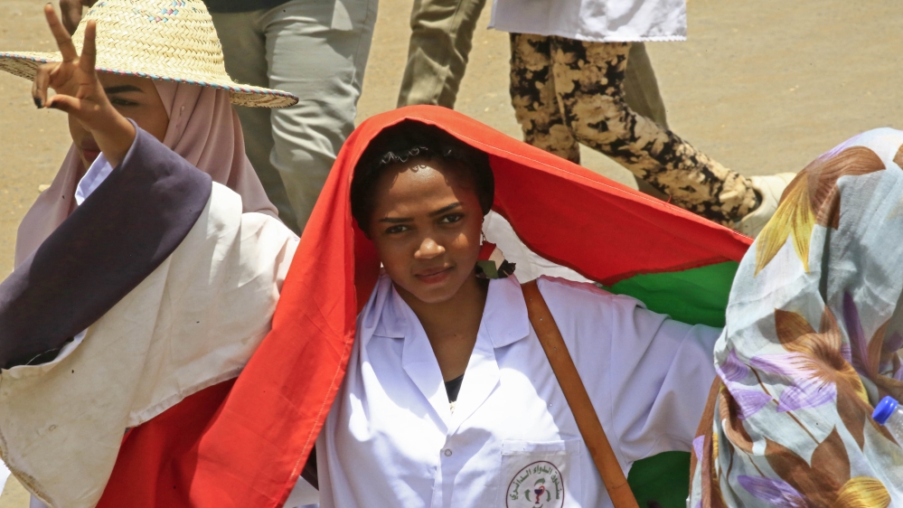 Hundreds of doctors in their white coats marched to join the Khartoum sit-in [Ashraf Shazly/AFP]