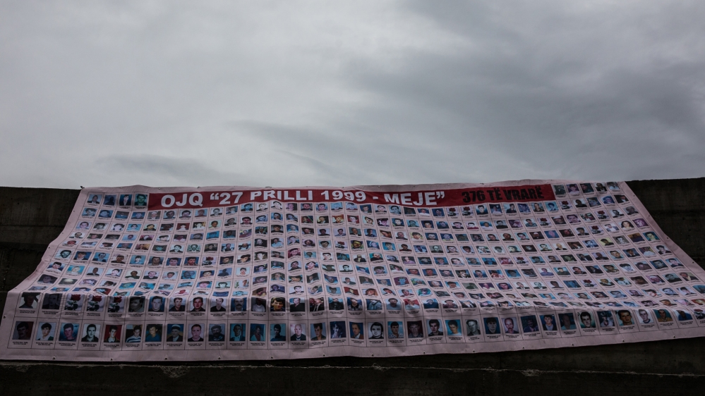 A banner showing the photos and names of the 376 ethnic Albanians killed on April 27, 1999 in Meja, Kosovo [Valerie Plesch/Al Jazeera]