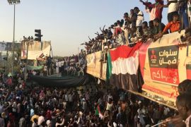 Sudanese demonstrators chant slogans as they attend a protest rally demanding Sudanese President Omar Al-Bashir to step down, outside Defence Ministry in Khartoum