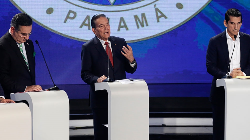 Presidential candidate Laurentino Cortizo, PRD, speaks between independent candidate Marco Ameglio, left, and Romulo Roux, CD, during a live, televised presidential debate organised by Panamanian Chamber of Commerce in Panama City [Arnulfo Franco/AP Photo]