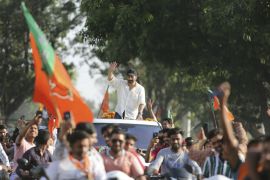 Bollywood actor and BJP candidate Sunny Deol waves to the crowd during an election campaign road show at Dinanagar in the northern state of Punjab on May 2, 2019 [AP Photo/Channi Anand]