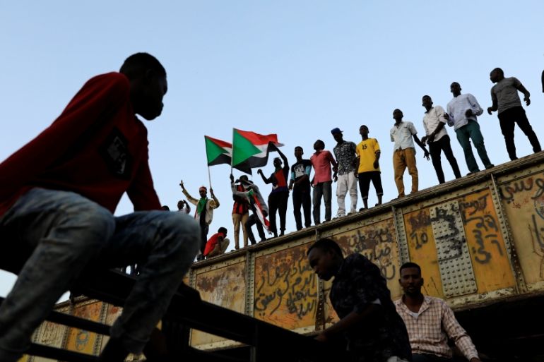 Sudanese protesters attend a demonstration in front of the defense ministry compound in Khartoum
