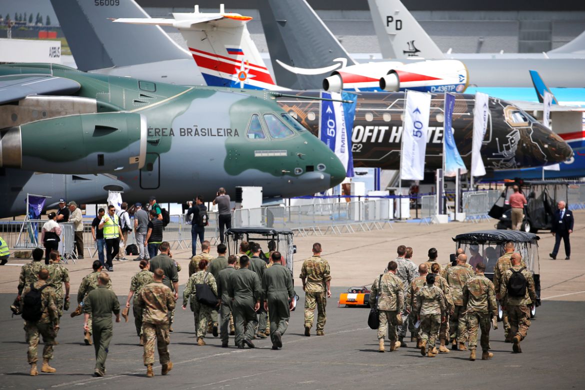 Soldiers walk past aircrafts on static display, at the eve of the opening of the 53rd International Paris Air Show at Le Bourget Airport near Paris, France, June 16 2019. REUTERS/Pascal Rossignol