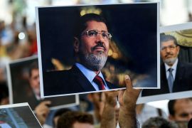 People hold picture of Egyptian President Mohamed Morsi during a symbolic funeral cerenomy on June 18, 2019 at Fatih mosque in Istanbul. Thousands joined in prayer in Istanbul on Tuesday