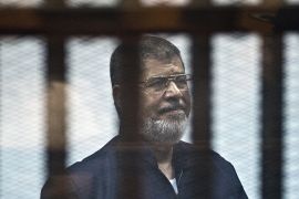 FILES) In this file photo taken on June 16, 2015 Egypt''s ousted Islamist president Mohamed Morsi stands behind the bars during his trial in Cairo. - Former Egyptian President Mohamed Morsi died on Jun