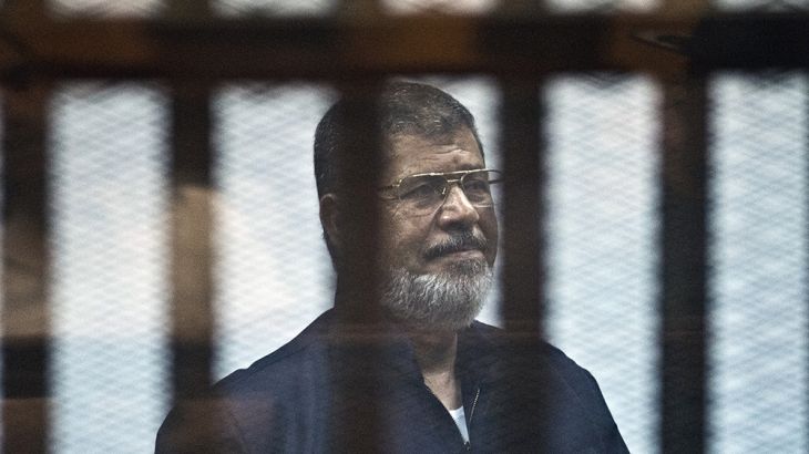FILES) In this file photo taken on June 16, 2015 Egypt''s ousted Islamist president Mohamed Morsi stands behind the bars during his trial in Cairo. - Former Egyptian President Mohamed Morsi died on Jun