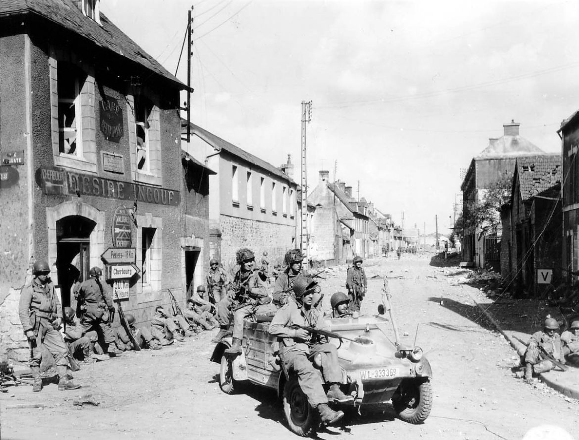 U.S. Army paratroopers of the 101st Airborne Division drive a captured German Kubelwagen on D-Day at the junction of Rue Holgate and RN13 in Carentan, France, June 6, 1944 in this handout photo provd