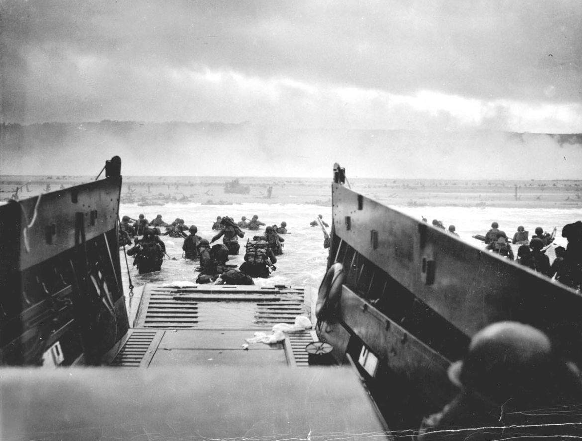 U.S. troops wade ashore from a Coast Guard landing craft at Omaha Beach during the Normandy D-Day landings near Vierville sur Mer, France, on June 6, 1944 in this handout photo provided by the US Nati
