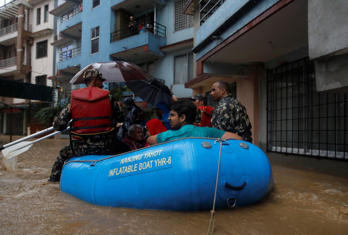 Residents are carried out on a boat in a flooded colony in Kathmandu, Nepal July 12, 2019. REUTERS/Navesh Chitrakar