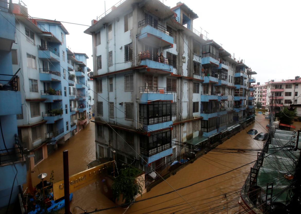 Residents look from a balcony to the flooded colony in Kathmandu Nepal July 12, 2019. REUTERS/Navesh Chitrakar