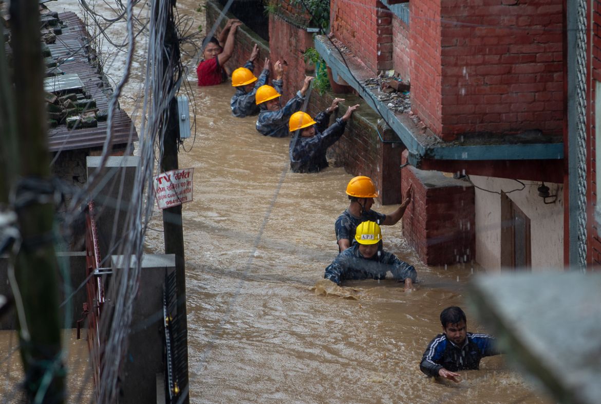 Members of armed police force rescue people from flooded houses following torrential rains in Kathmandu, Nepal, 12 July 2019. Meteorologists warned of heavy monsoon rains in Nepal that put several par