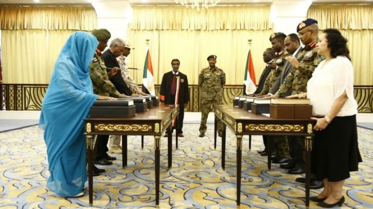 A picture released by Sudan''s Presidential Palace shows General Abdel Fattah al-Burhan (C-R), the head of Sudan''s ruling military council, standing during a swearing in of the new sovereign council, i