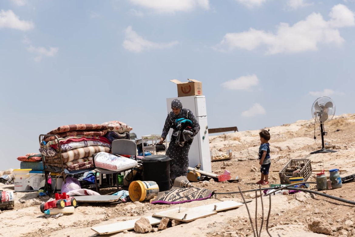 Reem moving her family’s possessions into a cave on the day her house was demolished. She arrived at Halawe four years ago as a young bride. Having a house of her own has remained an unattainable drea