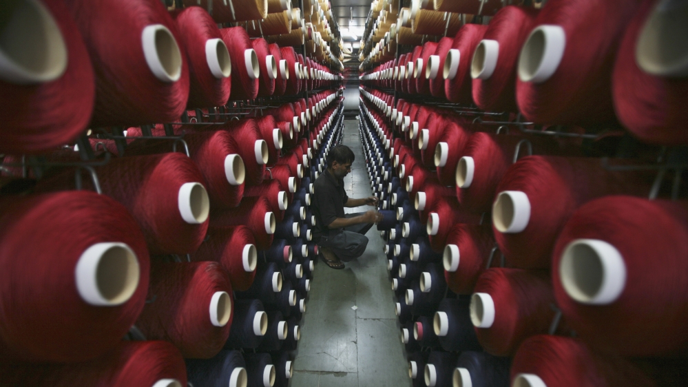 An employee works at the production line of a carpet manufacturing factory in Jammu September 12, 2013