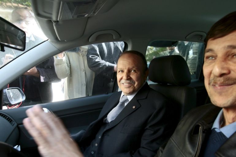 Algeria''s President Abdelaziz Bouteflika smiles as he arrives with his brother Said at his campaign''s communications department during a surprise visit in Algiers