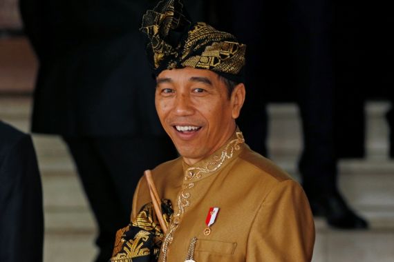 Indonesia''s President Joko Widodo reacts to reporters as he departs deliver address ahead of Independence Day at the parliament building in Jakarta