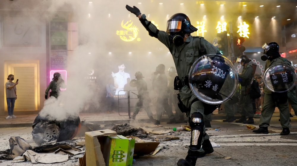 Riot police walk next to a street barricade during a demonstration in Mong Kok district in Hong Kong, China September 6, 2019