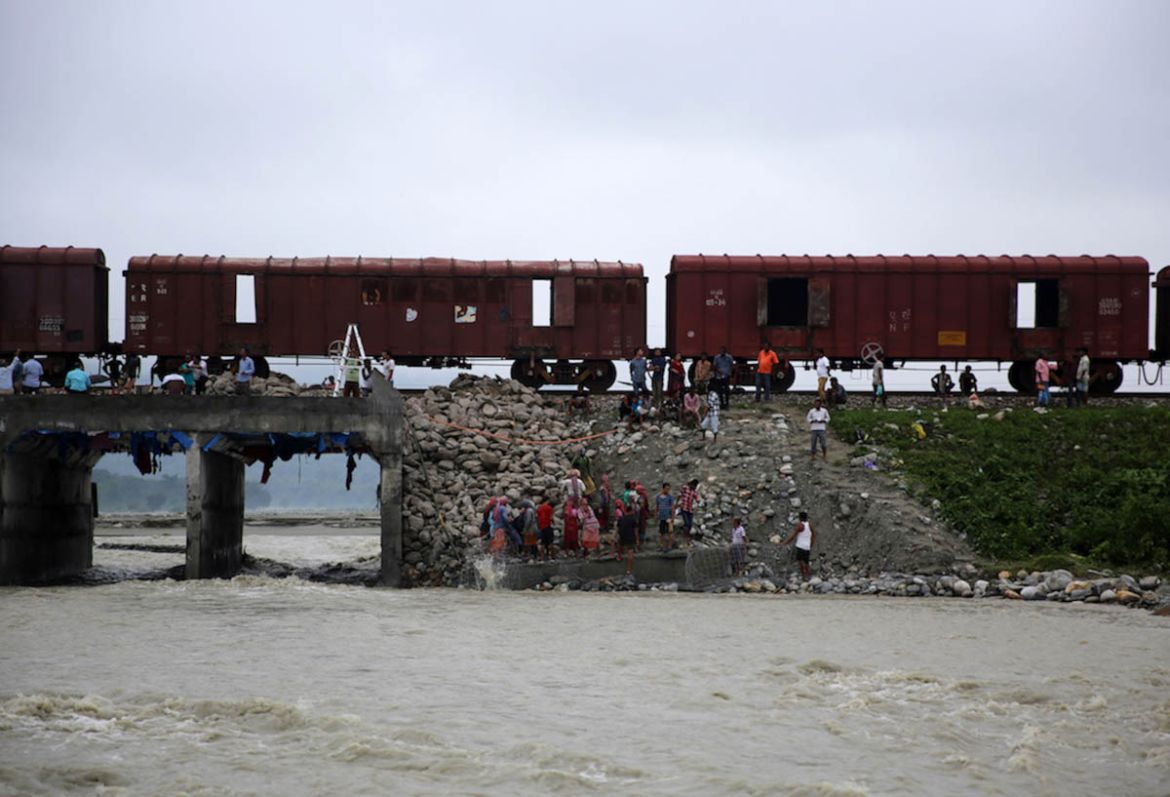 Stones carrying train halted at a bridge. These carriage trains move across the country carrying stones to construction sites.
