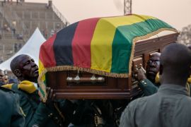 Soldiers carry the late President Mugabe''s casket  into the helicopter back the family mansion where it will lie in state until another public viewing is held tomorrow.  