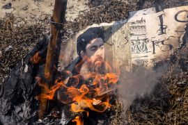 Shiite Muslims burn an effigy of the leader of the Islamic State group, Abu Bakr al-Baghdadi during a protest in New Delhi, India, Friday, June 9, 2017. The protest was against the Wednesday Islamic S