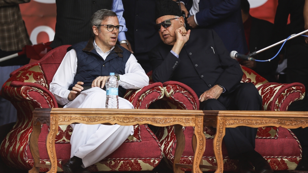 National Conference party president Farooq Abdullah, right and his son and former chief minister of Jammu and Kashmir Omar Abdullah, talk during an election rally in Srinagar, Indian controlled Kashmi