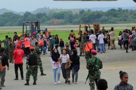 Residents from Wamena arrive with Indonesian military aircraft at Sentani Airport in Jayapura, Papua