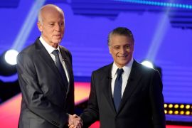 Tunisian presidential candidates Nabil Karoui and Kais Saied shake hands before a televised debate ahead of Sunday''s second-round runoff election in Tunis