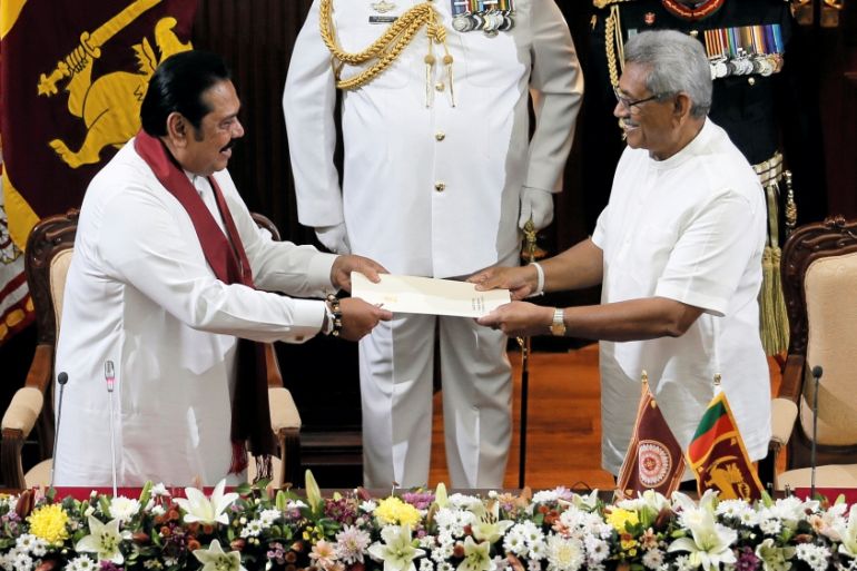 Sri Lanka''s President Gotabaya Rajapaksa hands over a document to his brother and former leader Mahinda Rajapaksa, who was appointed as the new Prime Minister