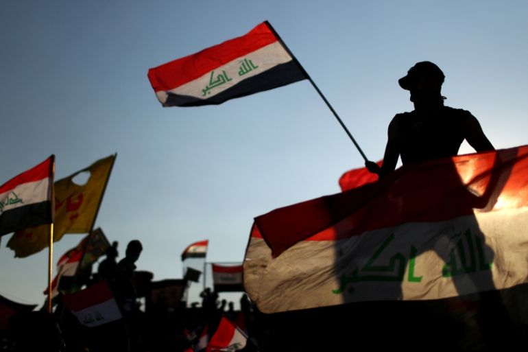 Iraqi demonstrators wave flags during the ongoing anti-government protests in Baghdad, Iraq November 1, 2019.