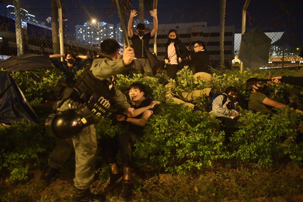 Police detain protesters and students after they tried to flee outside the Hong Kong Polytechnic University campus in the Hung Hom district of Hong Kong on November 19, 2019. - A dwindling number of e