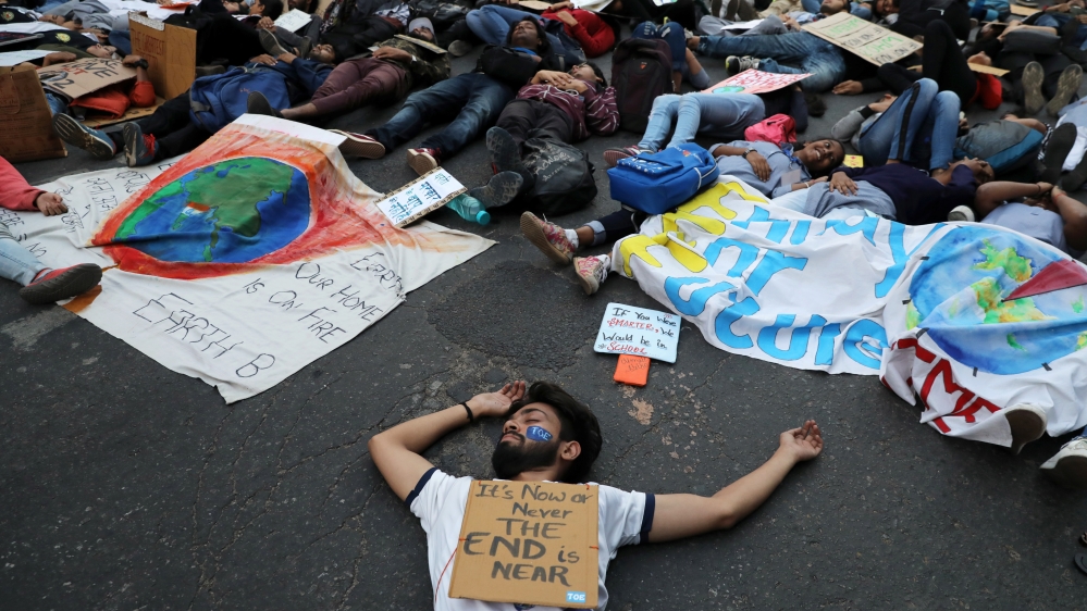 People stage a die-in during a Global Climate Strike rally calling for urgent measures to combat climate change, in New Delhi