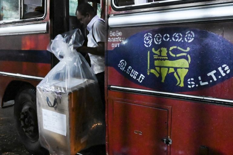 A Sri Lankan election official carries a ballot box to be transferred to a main counting centre after the presidential election voting centres closed, in Colombo on November 16, 2019