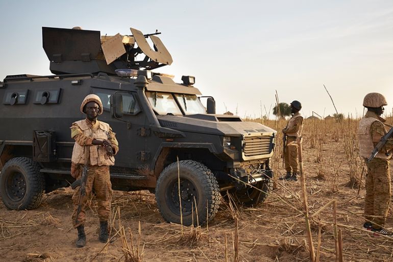 A group of soldiers from the Burkina Faso Army patrols a rural area during a joint operation with the French Army in the Soum region along the border with Mali on November 9, 2019. (Photo by MICHELE C