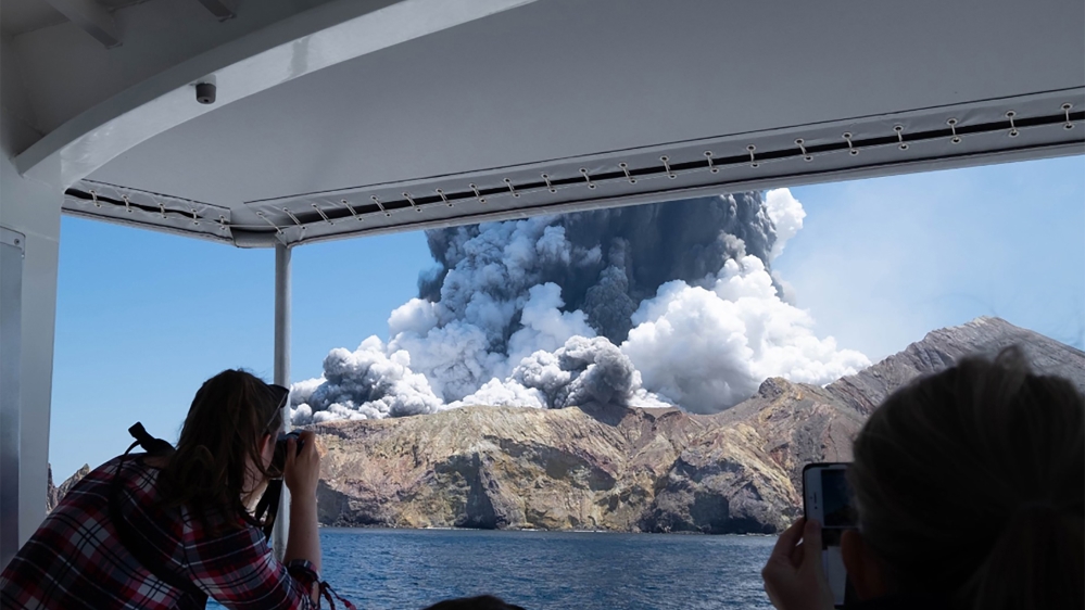 This handout photograph courtesy of Michael Schade shows the volcano on New Zealand's White Island spewing steam and ash moments after it erupted on December 9, 2019. New Zealand police said at least 