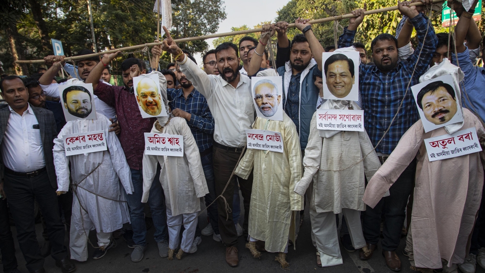 All Assam Student's Union (AASU) activists hang the effigies of Indian Prime Minister Narendra Modi, middle and Home Minister Amit Shah, second from left and Assam Chief Minister Sarbananda Sonowal, s