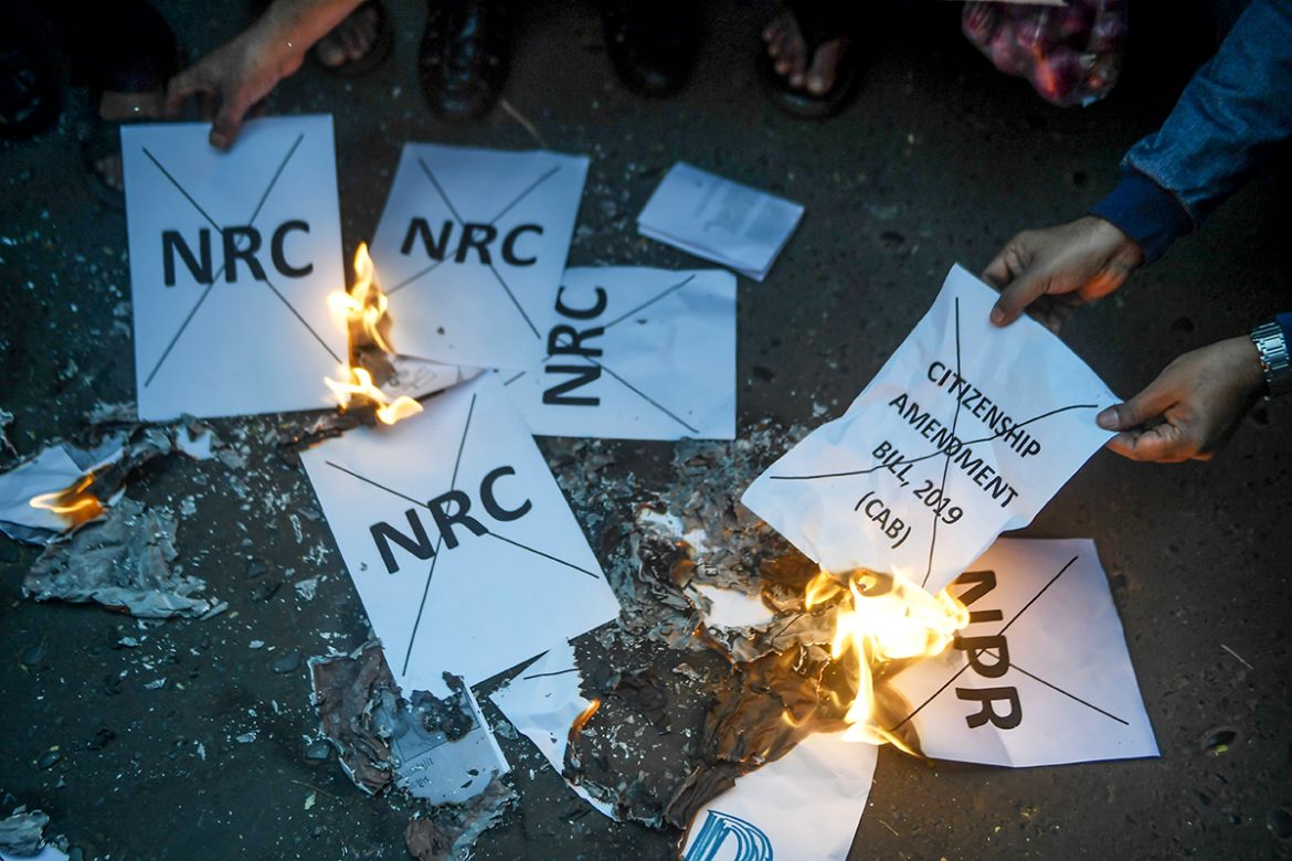 Social activists set fire to posters about the National Register of Citizens (NRC) and other civil rights'' issues like the Citizenship Amendment Bill 2019 (CAB) as they demonstrate against the Bharati